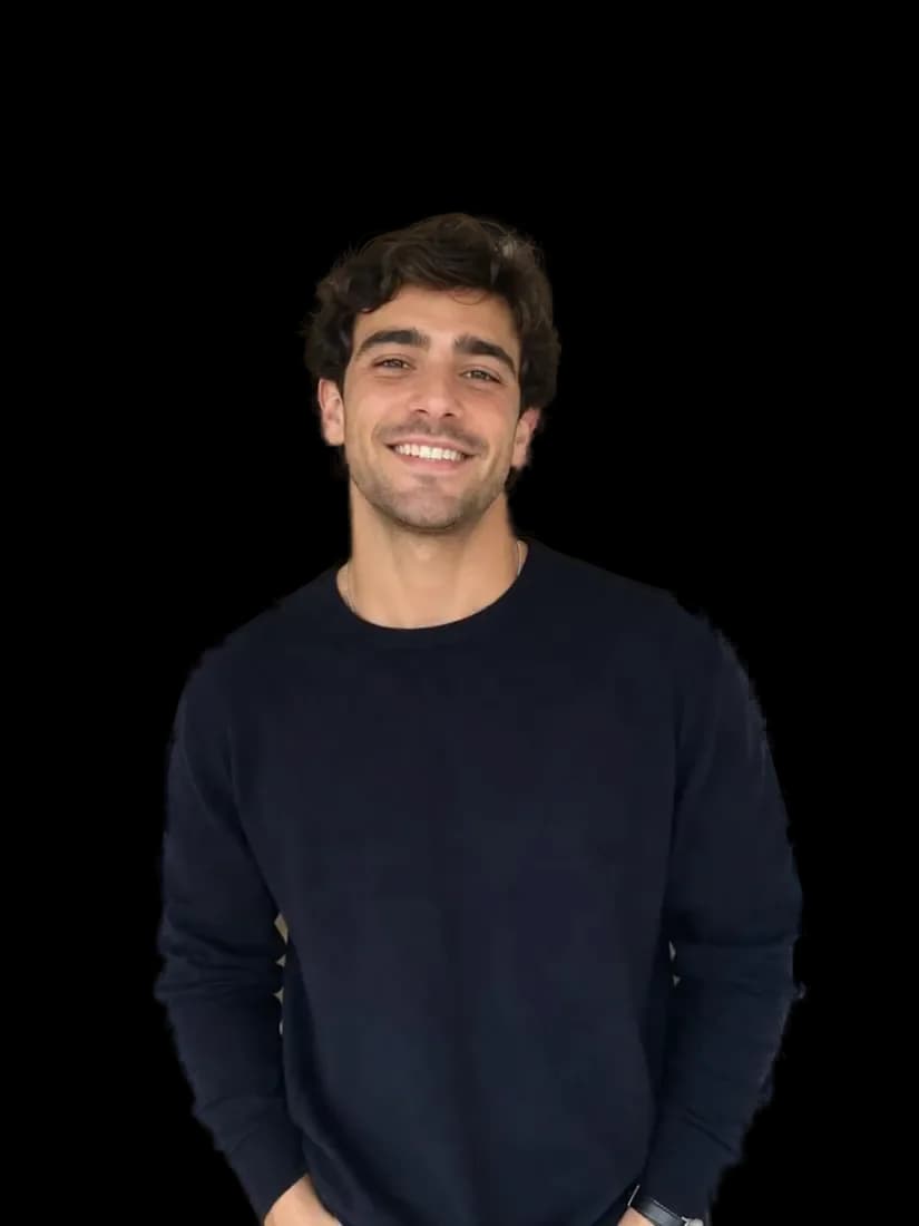 A smiling man in a navy sweater cut out from his photo with a transparent background, made with background removal.