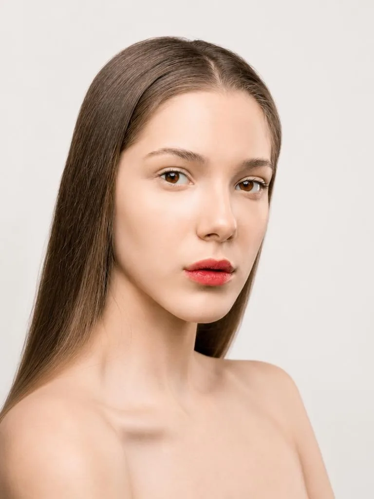 A close-up portrait shows clear, even skin after the Face Enhancer tool refines the complexion.