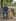 A man sits on a park bench beside a golden retriever, before the Image Replace tool swaps the dog for a cat.