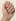The back of a woman's hand with natural unpolished nails, before the Nail Editor applies a French manicure.