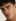 A man's close-up portrait shows clear, refined skin after the Skin Enhancer tool.