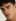 A man's close-up portrait appears before the Skin Enhancer tool refines his complexion.