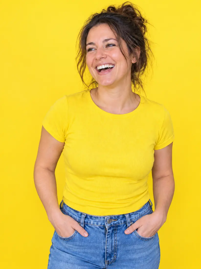 A laughing woman in a yellow t-shirt appears against vivid lemon yellow, placed there by the Yellow Background changer.