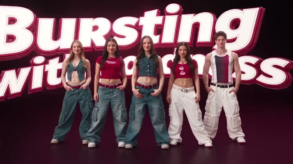 An AI soda ad of five young people in cargo pants and crop tops posing in front of giant "Bursting with" lettering.