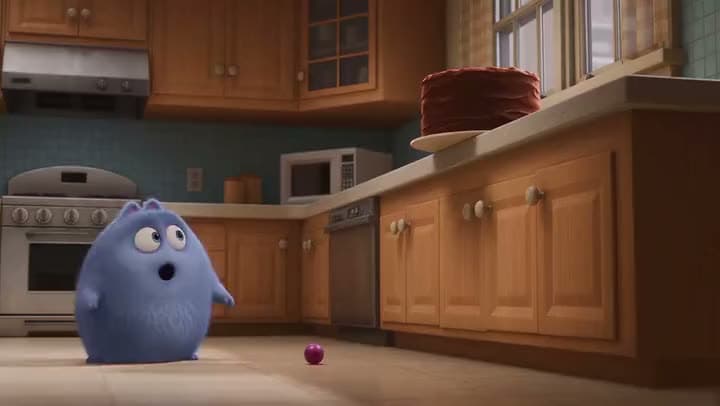 An AI animated clip of a fluffy blue creature staring up at a chocolate cake on a kitchen counter.