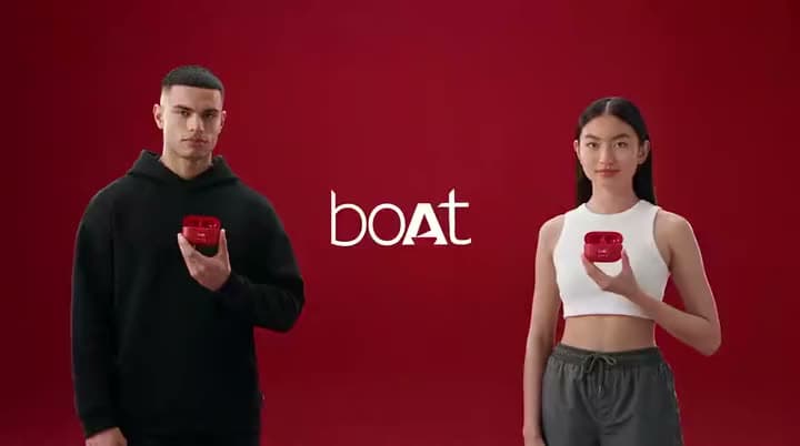 An AI product ad of a man in a black hoodie and a woman in a white tank top each holding red earbud cases beside a "boAt" logo.