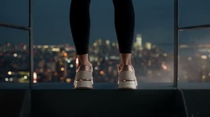 An AI video brand opener: a runner silhouetted against a night skyline, then a white sneaker under the NOVARA wordmark.